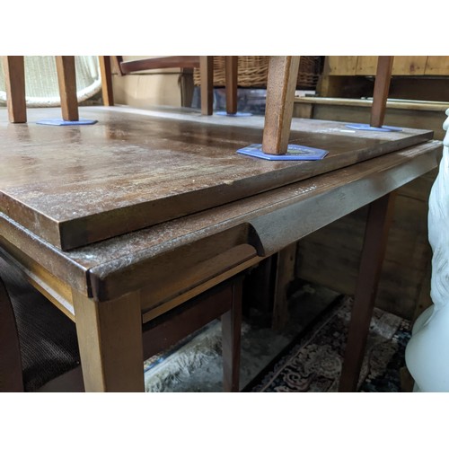 169 - An oak draw leaf extending dining table on turned legs united by cross stretchers on block feet, alo... 