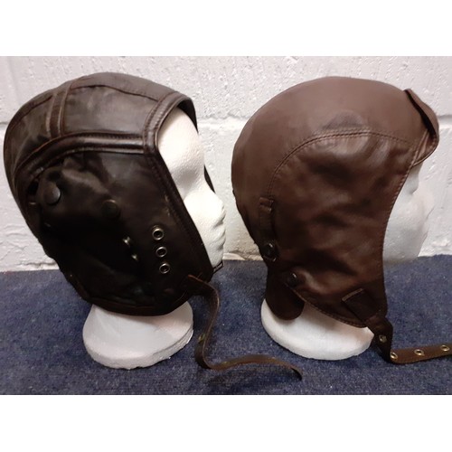 104 - Four vintage soft leather flying helmets to include
Cirrus examples and an army canvas bag. Location... 