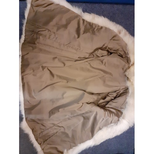 110 - A late 20th Century arctic fox jacket having a shawl collar and a brown satin lining, approx 38