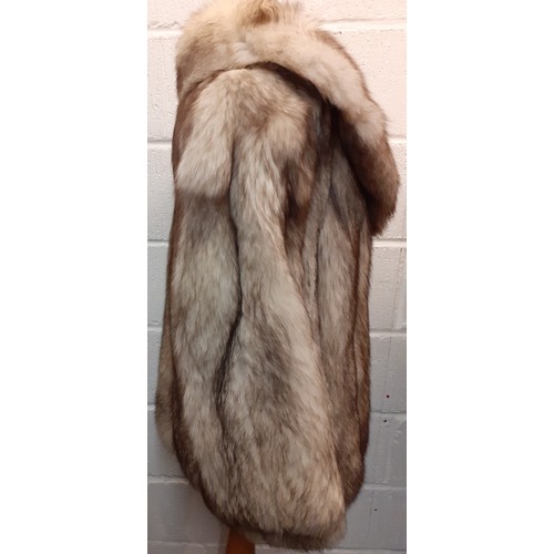 111 - A late 20th Century arctic fox fur coat with brown shades having a shawl collar, grey satin lining a... 