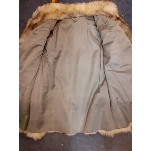 111 - A late 20th Century arctic fox fur coat with brown shades having a shawl collar, grey satin lining a... 