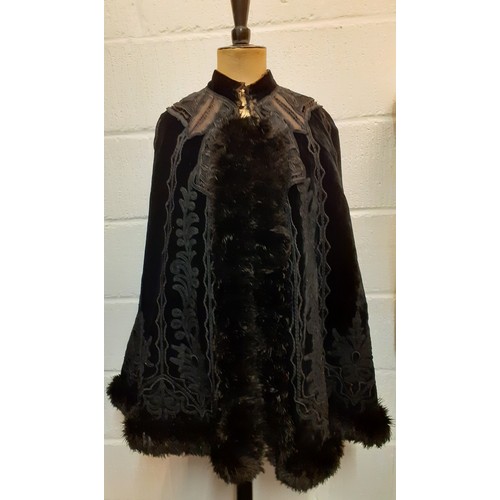 117 - A Victorian Jays Ltd of London black velvet mourning cape A/F having a black ostrich feather trim wi... 