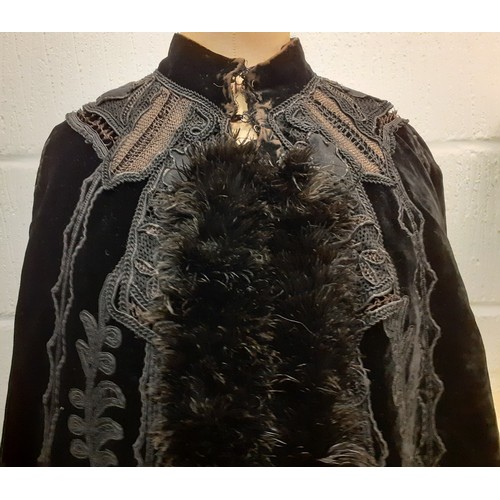 117 - A Victorian Jays Ltd of London black velvet mourning cape A/F having a black ostrich feather trim wi... 