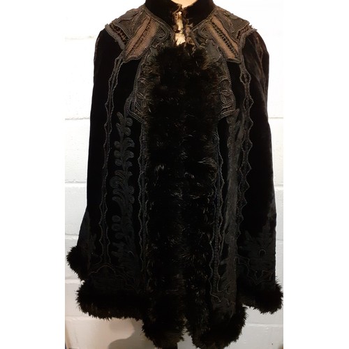 117 - A Victorian Jays Ltd of London black velvet mourning cape A/F having a black ostrich feather trim wi... 