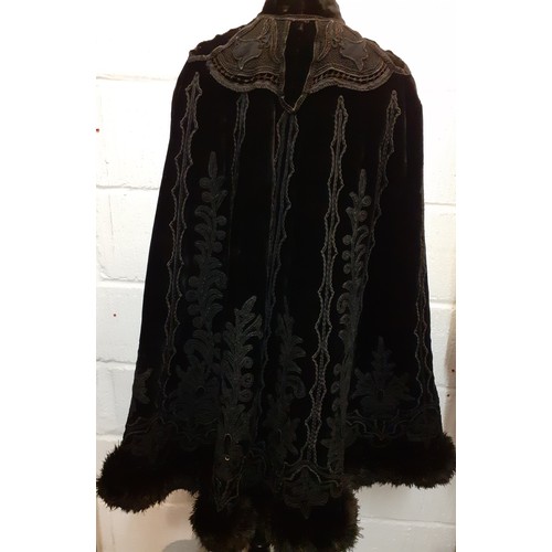 117 - A Victorian Jays Ltd of London black velvet mourning cape A/F having a black ostrich feather trim wi... 