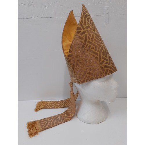 108 - An ecclesiastical mitre in a gold coloured fabric and tassels, 11