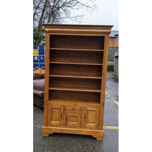 202 - A modern French style oak sideboard with three drawers and three doors, on bracket feet, 198cm long,... 