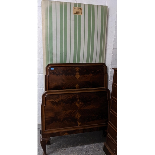 171 - An early 20th century Bartholomew & Fletcher mahogany single bed headboard and footboard with matter... 