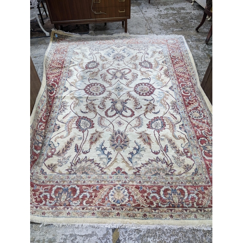 174 - A contemporary hand woven Afgan Zeigler rug, all over floral pattern on a sandy coloured ground, mul... 