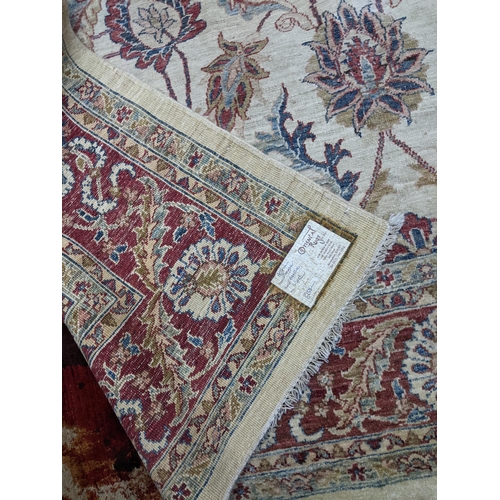 174 - A contemporary hand woven Afgan Zeigler rug, all over floral pattern on a sandy coloured ground, mul... 