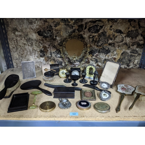 184 - A mixed lot to include two silver strict photograph frames and one other dressing table brush sets, ... 