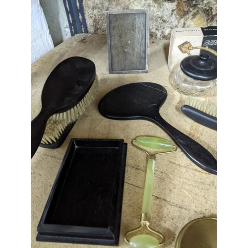 184 - A mixed lot to include two silver strict photograph frames and one other dressing table brush sets, ... 