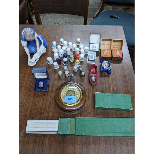 185 - A collection of glass, porcelain, silver and other metal thimbles, to include a Victorian thimble in... 