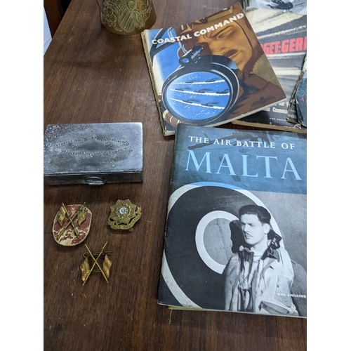 193 - A selection of items of military interest to include three WWII cap badges and a mess tin, a Saudi A... 