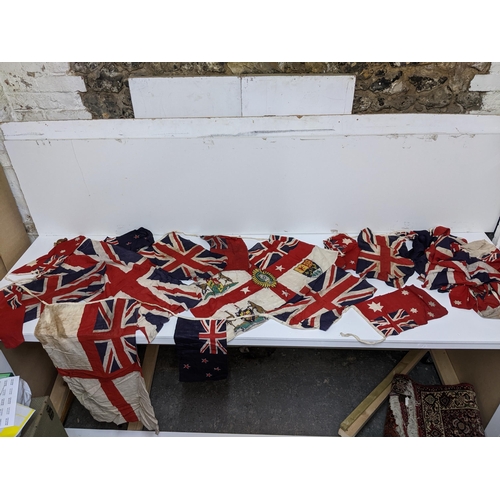 194 - A group of British Empire yachting flags, ensigns, and bunting to include a British Empire flag, cir... 