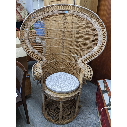 278 - A mid-century wickerwork peacock chair with a woven cane seat A/F with loose cushion Location:G