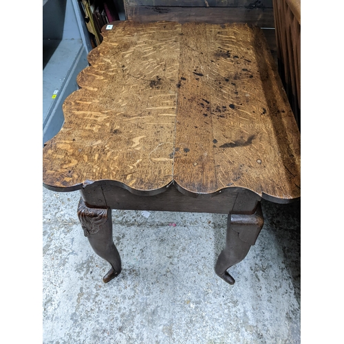 288 - A 19th century oak lowboy with a shaped top, over a drawer, on carved cabriole legs, 75cm x 84cm x 6... 