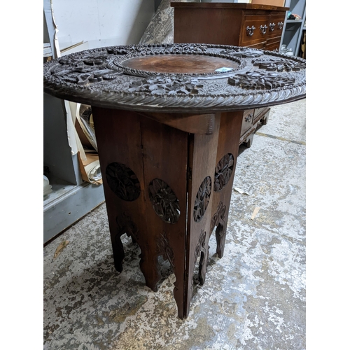 292 - An early 20th century carved hardwood table of a folding octagonal base
Location:G