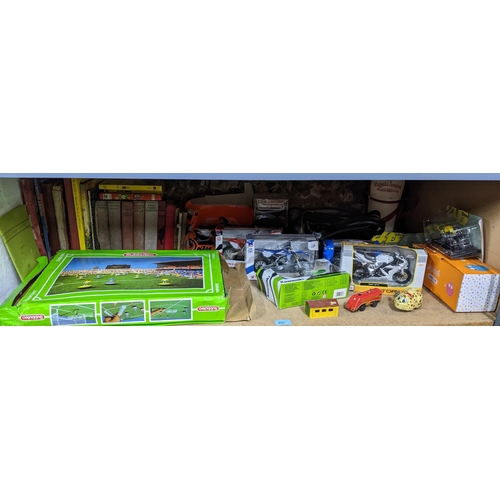 297 - A mixed lot of toys and books to include a boxed Subbuteo game, boxed die model motor bikes, tinplat... 