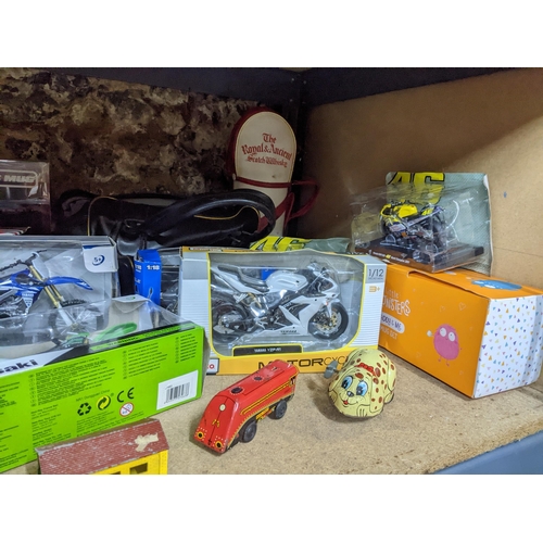 297 - A mixed lot of toys and books to include a boxed Subbuteo game, boxed die model motor bikes, tinplat... 