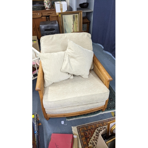 196 - A modern Ercol oak framed Bergère armchair with carved sides Location:A2F