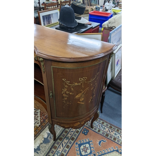 10 - An Edwardian mahogany cabinet having marquetry inlaid and gilt metal mounts, central drawer above op... 