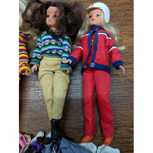 139 - Six 1980's Sindy dolls stamped 033055X to the rear of the neck wearing clothing and footwear togethe... 