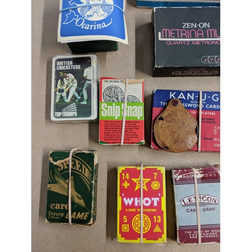 147 - Mixed musical instruments and various card games to include Top Trumps, Snip Snap a recorder, a Hohn... 