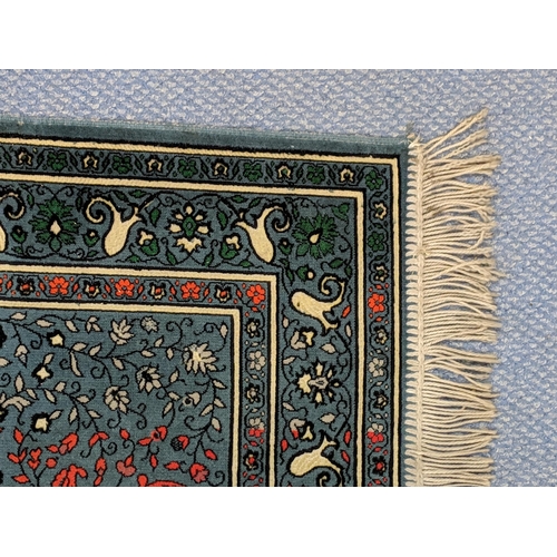 151 - A Turkish rug with multicoloured symmetrical decoration on a dark blue background 67cm 119cm
Locatio... 