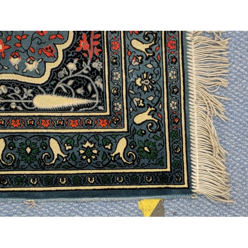 151 - A Turkish rug with multicoloured symmetrical decoration on a dark blue background 67cm 119cm
Locatio... 