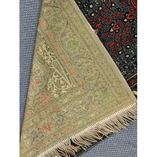 151 - A Turkish rug with multicoloured symmetrical decoration on a dark blue background 67cm 119cm
Locatio... 