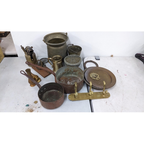 21 - A mixed lot of metalware to include oil lamps, cutlery, retro limit fan, jug pans and other items
Lo... 