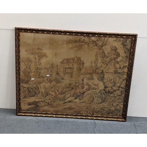 216 - A framed and glazed tapestry depicting a country scene, a man playing his flute, children with a goa... 