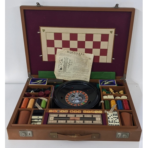 225 - A brown leather cased games set including roulette, chess etc
Location:LAB