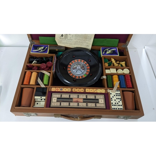 225 - A brown leather cased games set including roulette, chess etc
Location:LAB