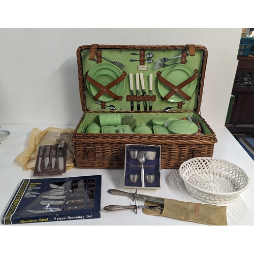 232 - A mixed lot to include a Coracle picnic set with wicker basket along with kitchen knives, stainless ... 