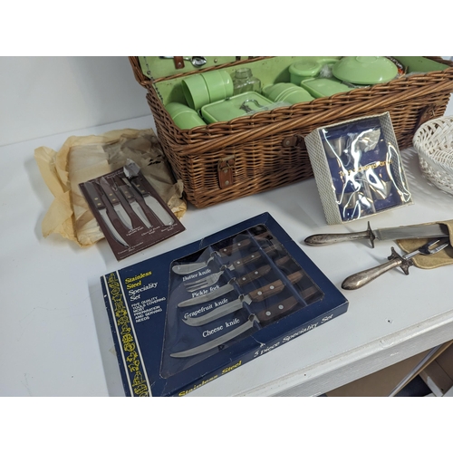 232 - A mixed lot to include a Coracle picnic set with wicker basket along with kitchen knives, stainless ... 