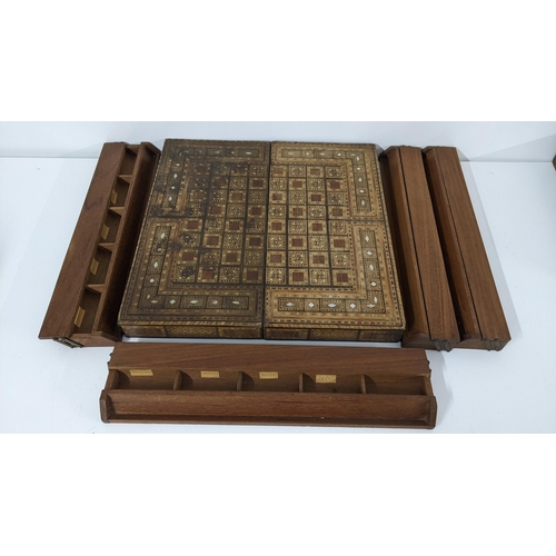 233 - An early 20th century Middle Eastern folding games board together with four game pieces boxes
Locati... 