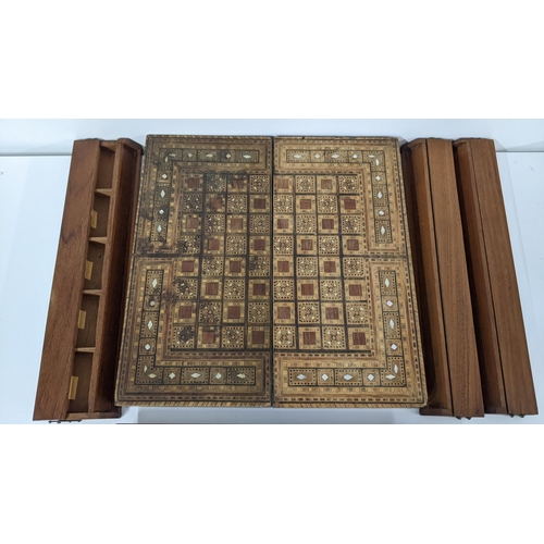 233 - An early 20th century Middle Eastern folding games board together with four game pieces boxes
Locati... 