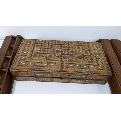 233 - An early 20th century Middle Eastern folding games board together with four game pieces boxes
Locati... 