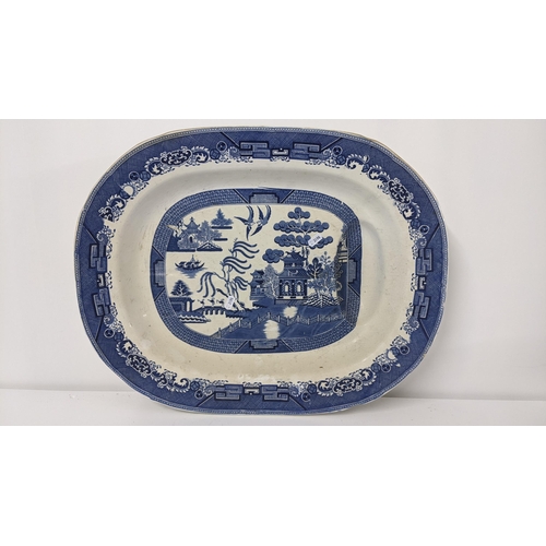 240 - An early 19th century pearlware Old Willow pattern meat plate with gravy well, 57.5cm
Location:LAM