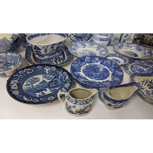 245 - A mixed lot of 19th century and later blue and white to include an Old Willow pattern soup tureen an... 