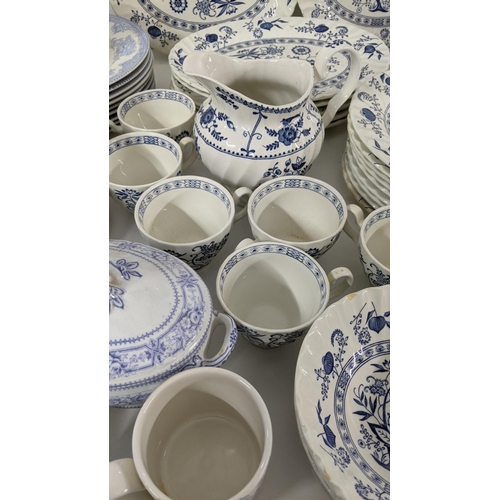 254 - A large collection of blue and white teal dinner services, to include Johnson brothers service and o... 