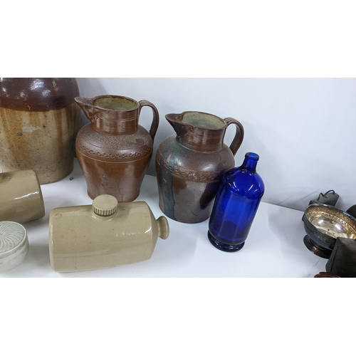 259 - A mixed lot to include a Jones & Rye Witney salt glazed flagon, two footwarmer, a Chiltern Hills wat... 