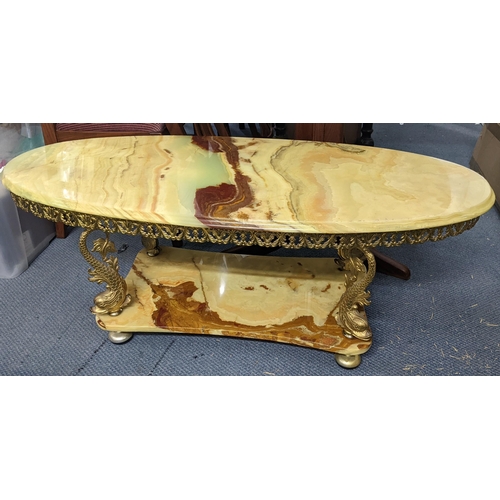 325 - A vintage only two tier coffee table having gilt metal dolphins shaped supports 46hx117w
Location:LA... 