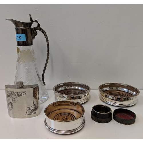 393 - Metalware to include a silver plated and glass caret jug, three bottles coasters and a hip flask
Loc... 