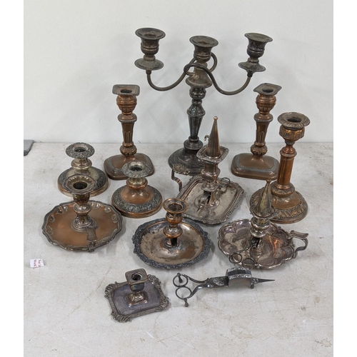 83 - A three branch candelabra, silver on copper plated together with a pair of candlestick holders along... 