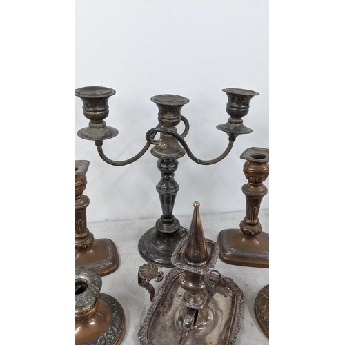 83 - A three branch candelabra, silver on copper plated together with a pair of candlestick holders along... 