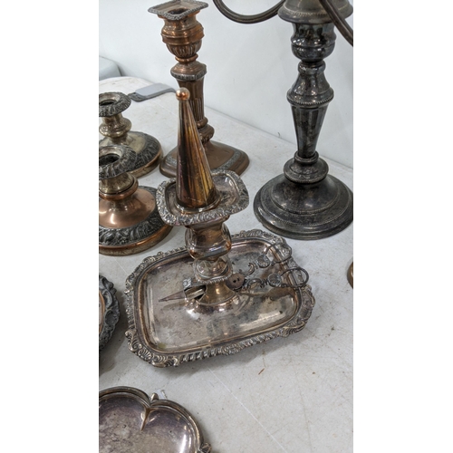 83 - A three branch candelabra, silver on copper plated together with a pair of candlestick holders along... 