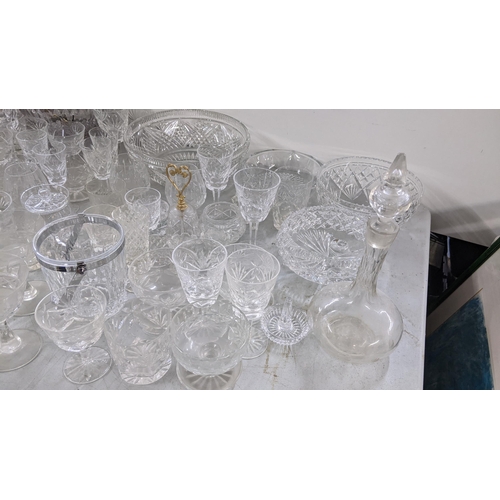 9 - A large mixed lot of glassware to include crystal cut decanters, Stuart bowl, hock glasses and other... 